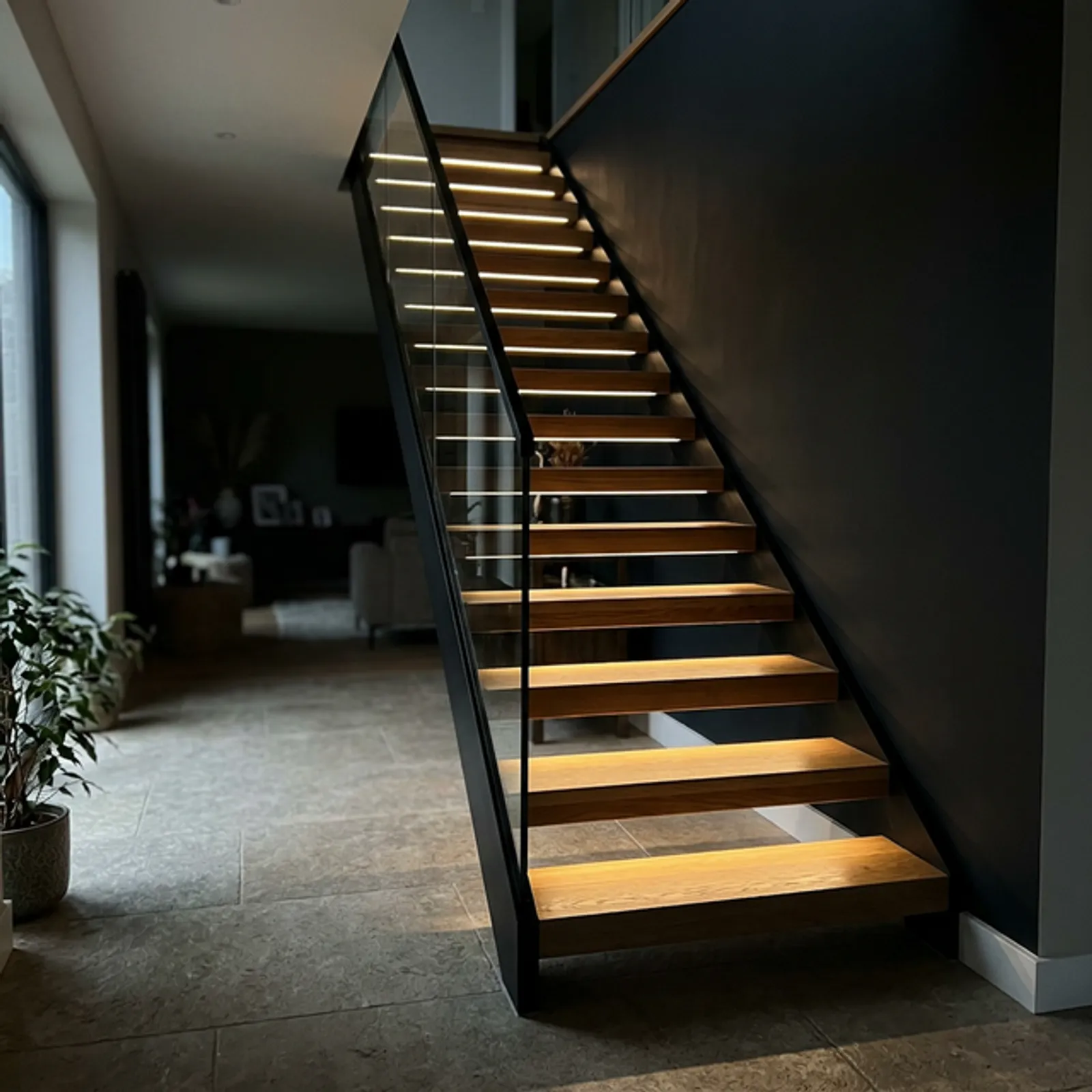 Floating staircase with integrated LED channel lighting under the treads